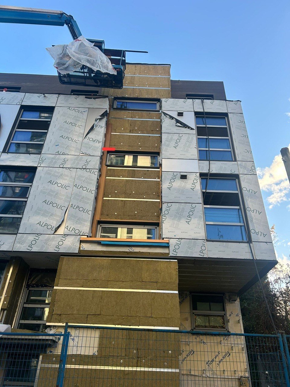1188 Burnaby man-lift cladding work with mineral wool insulation
