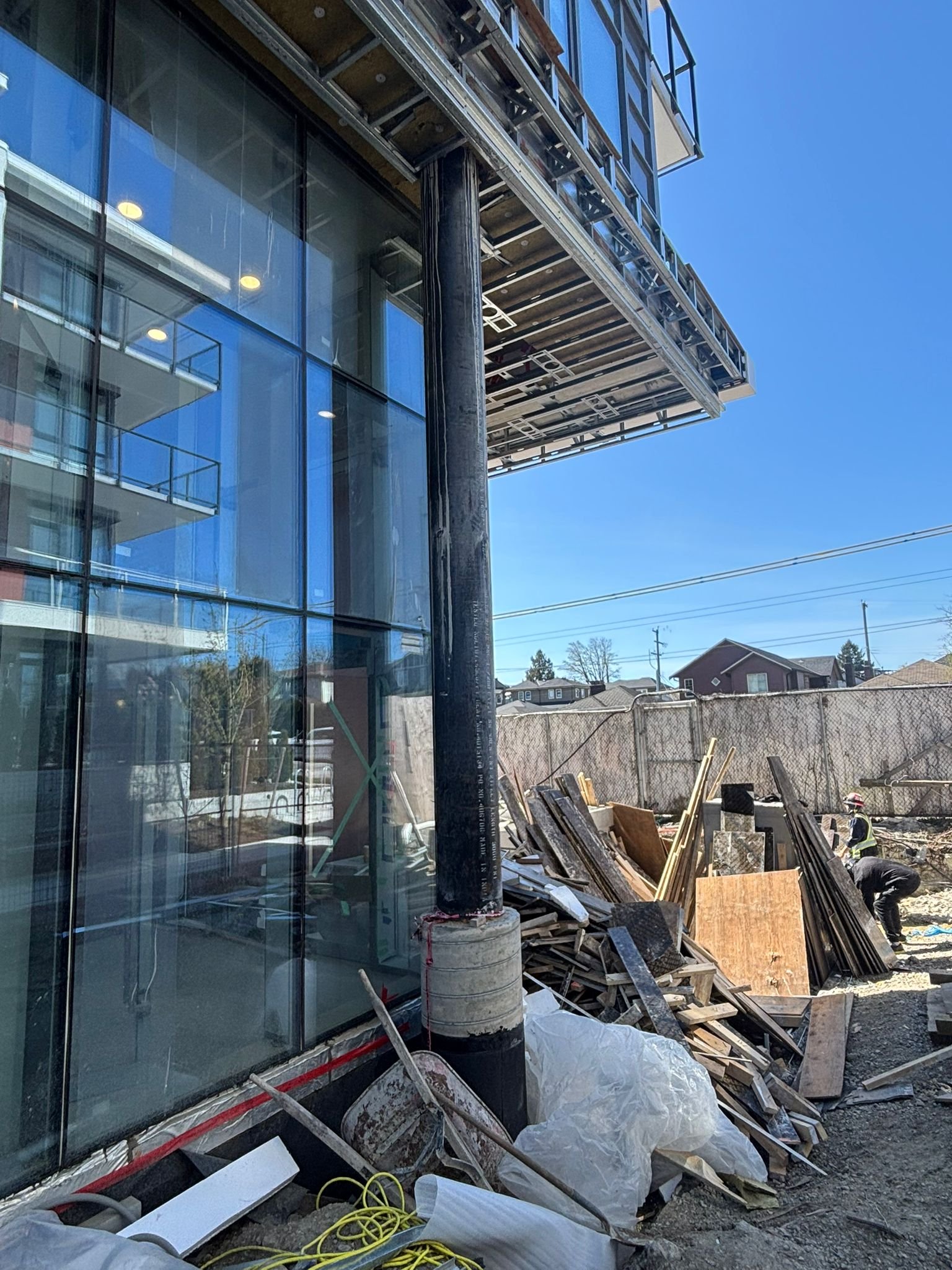 North Side ground-level glazing and curtain wall on an active job site