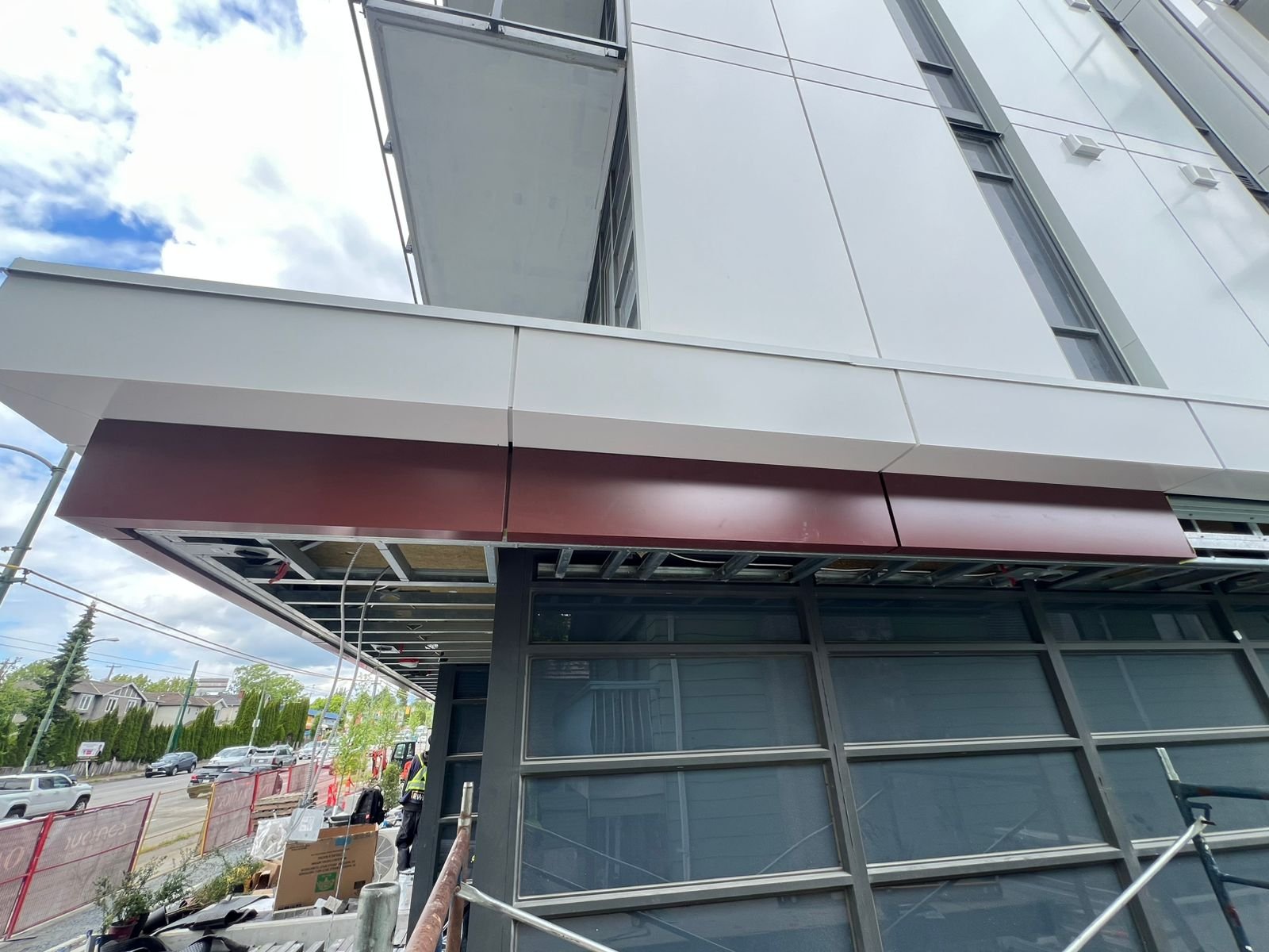 Deep-red 3 mm aluminium plate ACM fascia and soffit detail at the building corner
