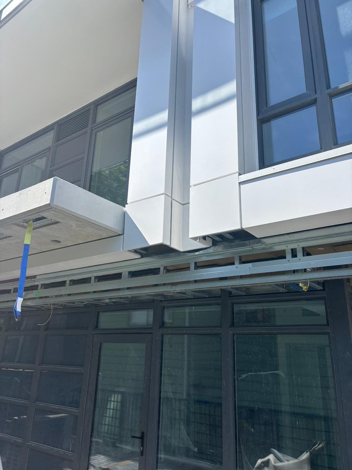 White aluminium composite panel column and window fascia detail at Oakmont